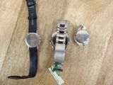 two watches sitting on a wooden table next to each other