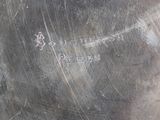 a silver pot that has writing on it