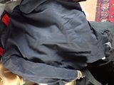 a person sitting on a chair with a backpack and a cat