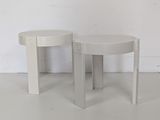 pair of white side tables in the style of person