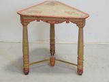 a small wooden table with a painted design on it