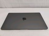 an apple macbook pro laptop sitting on top of a white table