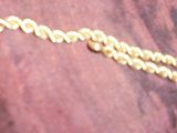 une photo d'un collier en or sur lequel est inscrit le mot « coco »