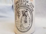 a white cup that has a picture of a man on a bicycle on it