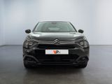 the front view of a black citrole parked in a white room