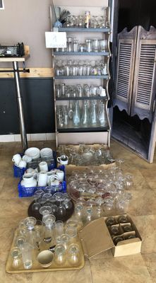 many empty glasses and containers on the floor in the kitchen