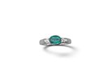 a close up of a ring with a green stone on it