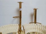 two chairs and a table with a candle holder on it