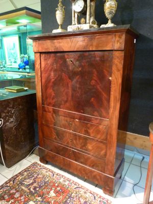 a cabinet with a clock on top of it in a room