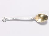 silver spoon on a white surface with a silver spoon in the middle