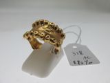 une image d'une bague en or sur une surface blanche avec une étiquette de prix