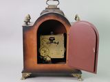 a clock that is sitting inside of a wooden case