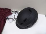 a helmet sitting on top of a table next to a t - shirt