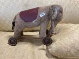 a stuffed elephant that is sitting on a pillow