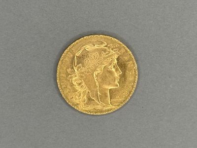 a close up of a gold coin on a gray surface