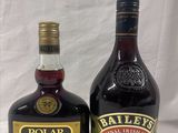 two bottles of liquor sitting next to each other on a table
