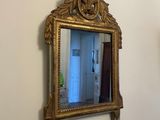 a mirror on the wall above a sink in a bathroom