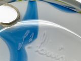a close up of a glass plate with a piece of paper on it