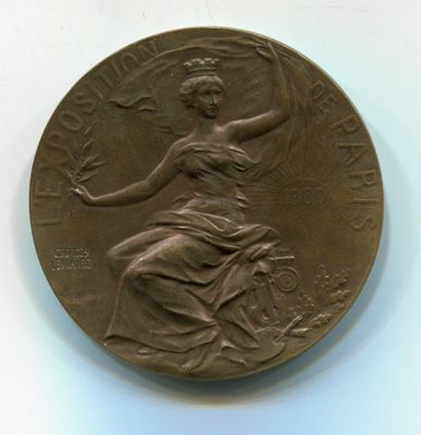 an old bronze medal with a woman holding a bird on it ' s back