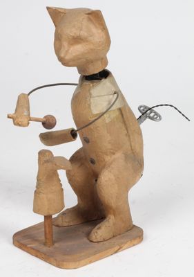 une sculpture en bois représentant un chat avec un oiseau sur le dos