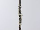 a close up of a clarinet on a white surface