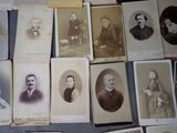 several old photographs of men and women are displayed on a table