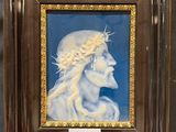 portrait of a woman with a crown of thorns on her head in a wooden frame