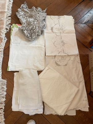 many pieces of cloth laid out on the floor next to each other