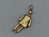 an image of a gold charm with a man holding a baseball bat