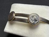 a close up of a cuff with a coin on it