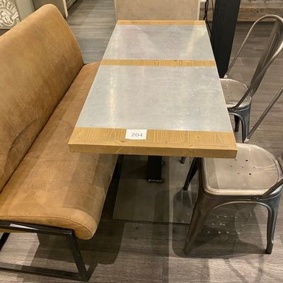 une table avec un banc et des chaises dans une pièce