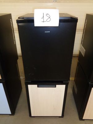 three black and white refrigerators with a price tag on them