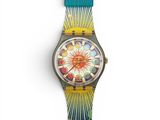 a close up of a watch on a white surface with a blue strap