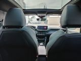 two seats in the back of a car that are facing the street