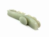 a piece of jade that is sitting on a white surface