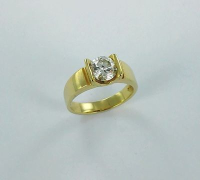 a yellow gold ring with a diamond on top of it