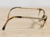 a pair of glasses sitting on a wooden table
