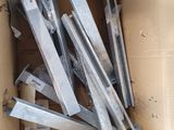 a cardboard box with a bunch of pieces of metal in it