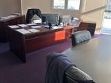 une grande table et des chaises dans un bureau donnant sur l'extérieur