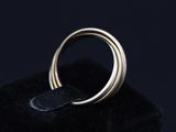 a close up of a gold ring on a black cloth