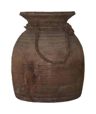 a large brown vase with a rope handle on it