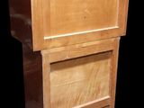 a wooden cabinet with a drawer on top of it