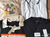 several t - shirts are laid out on a cardboard box on a table