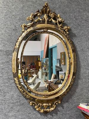 a mirror hanging on a wall in a room