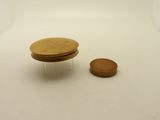 a small wooden table with a coin on it
