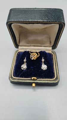 a close up of a ring and earrings in a box