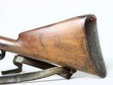 an old rifle with a wooden barrel on a white background
