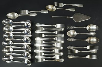 a lot of spoons and forks laid out on a table