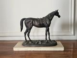 a statue of a horse standing on a marble base