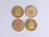 four different types of coins are shown on a white surface